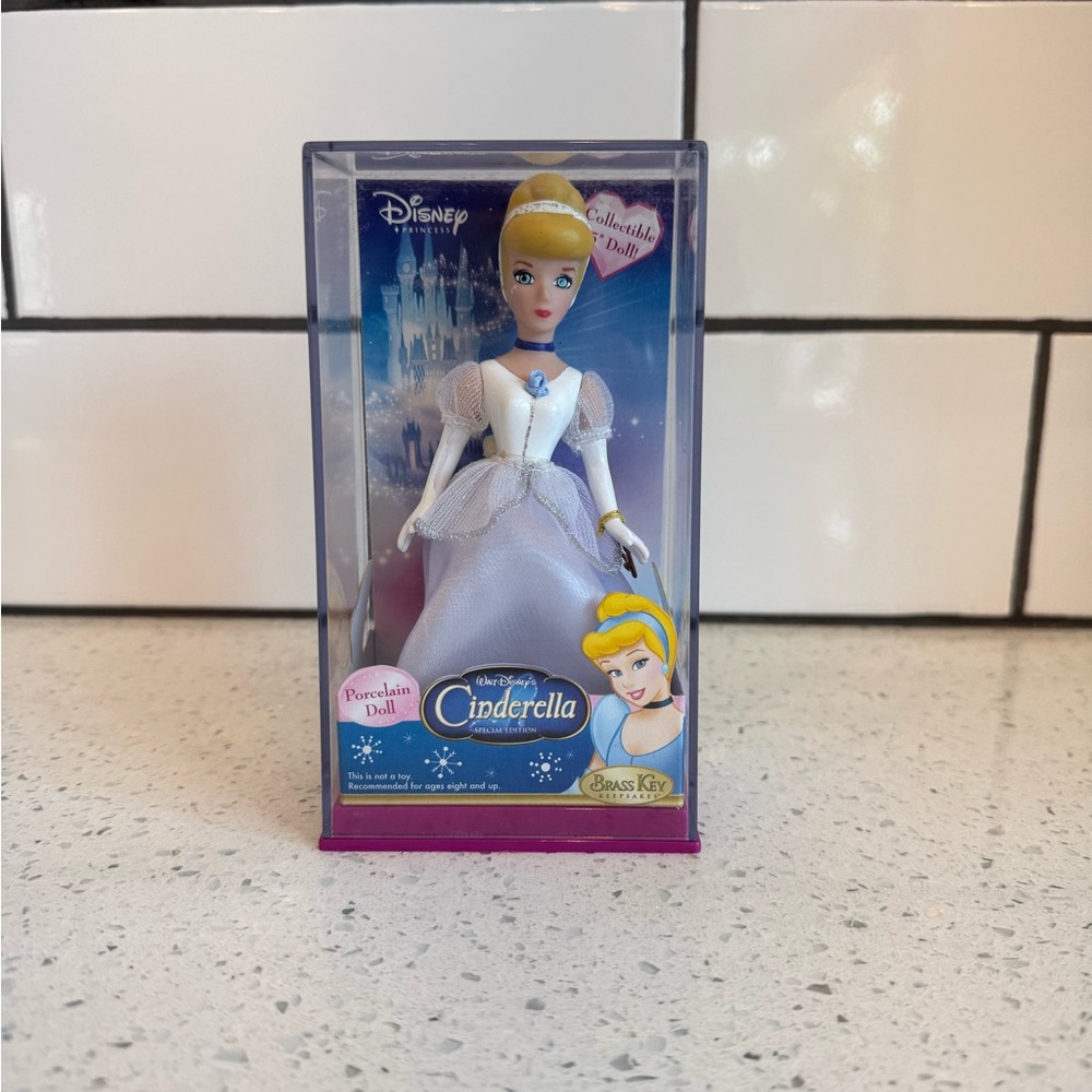 NIB-Disney Cinderella Brass Key Porcelain Doll White and Blue Elegant Princess